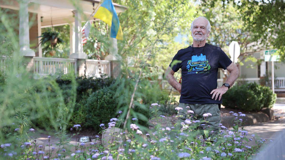 Lou Lesesne stands in his front yard that has pollinating flowers Wednesday, Sept. 24, 2025 in Charlotte.