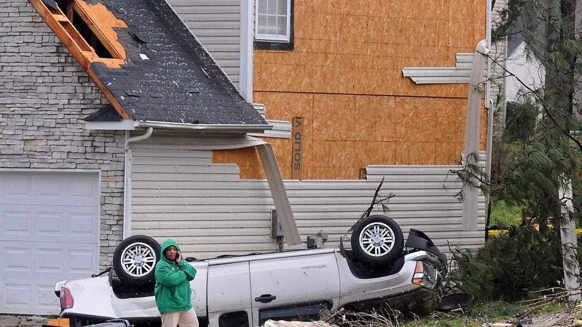 
Residents examine the damage on Satterfield Court in northeast Charlotte following a tornado on March 3, 2012. The National Weather Service never saw the Charlotte storm coming. Some meteorologists blame the lack of a Doppler radar unit in Charlotte for failing to detect the system until after it struck.

