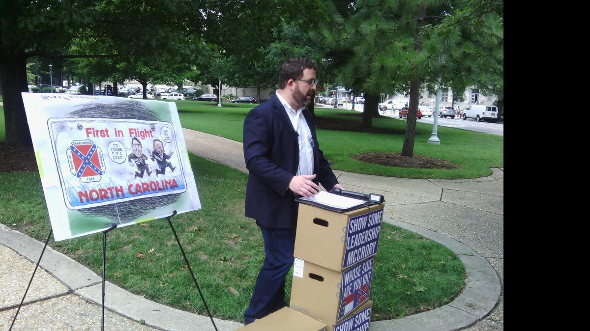 
Kevin Rogers of the liberal advocacy group Action NC speaks to reporters about a petition calling on Gov. Pat McCrory to end Confederate flag license plates. 
