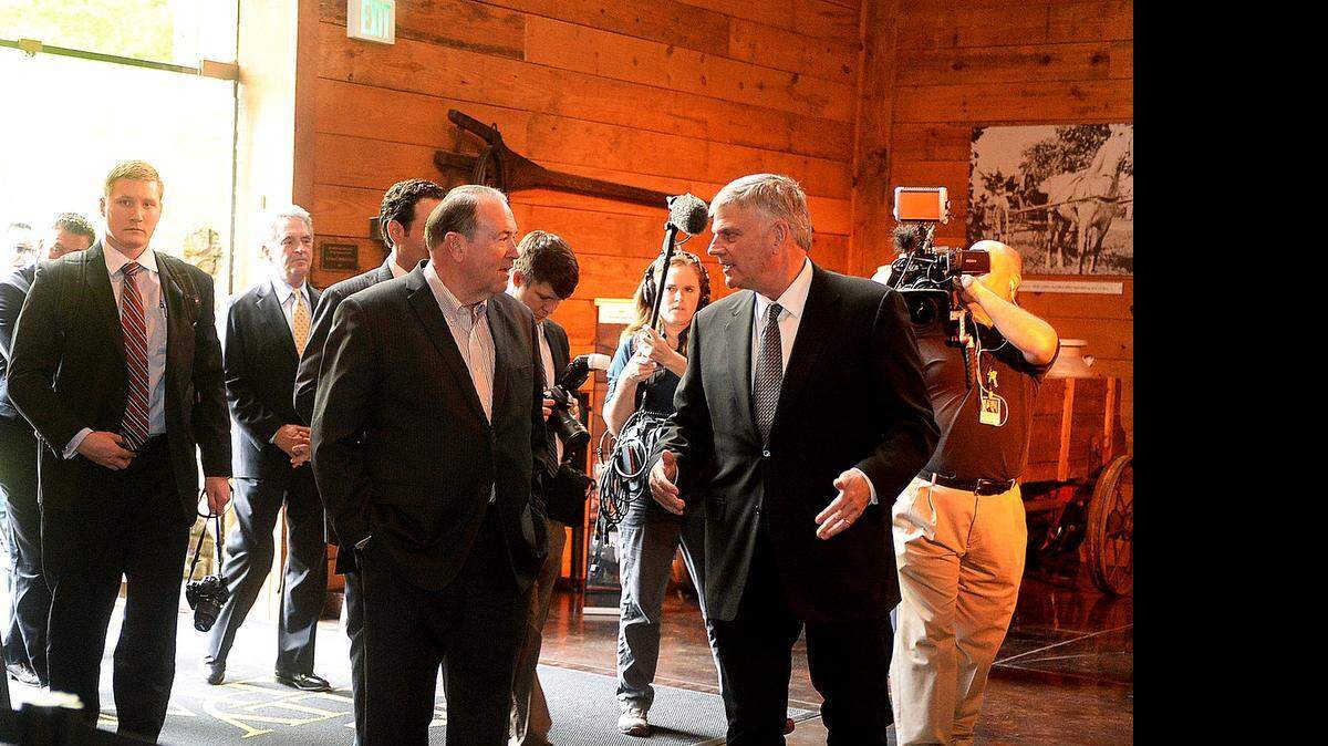 
Former Arkansas Governor and likely 2016 GOP presidential candidate Mike Huckabee, left, and Evangelist Franklin Graham, right, enter the Billy Graham Library for a tour prior to Huckabee's press conference at the Library on Thursday April 23, 2015. Huckabee returned to Charlotte on April 23 to sign copies of his new book "God, Guns, Grits and Gravy"at the Billy Graham Library. Huckabee is a former Baptist pastor who is popular with evangelical Christian voters. In January, he signed books and spoke during an appearance at First Baptist Church of Charlotte. 
