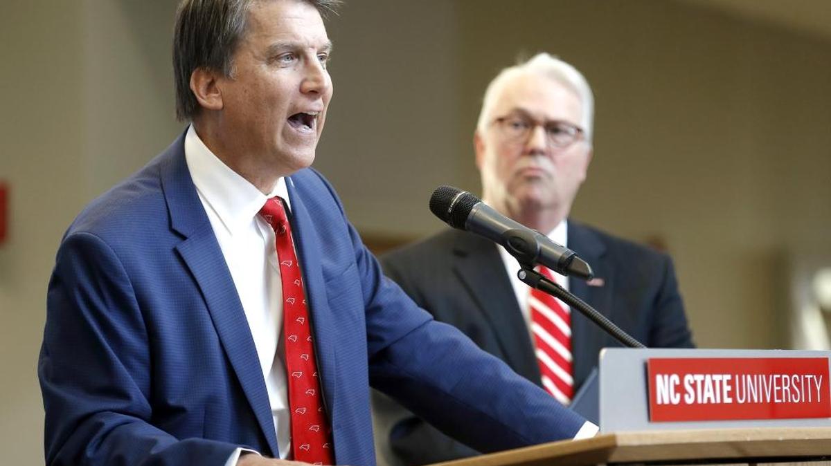 In a ceremony filled with leaders from a variety of state agencies, Governor Pat McCrory, left, speaks before he signs the bill that puts his bonds issue before voters during an event held on the N.C. State Centennial Campus in Raleigh on Oct. 21, 2015. N.C. State Chancellor Randy Woodson listens at right. The proposal, called Connect NC, targets investments in North Carolina's education, public health, parks and military, from small farming towns to large cities.