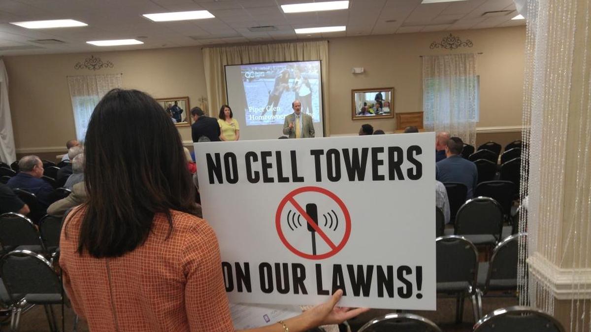 About 100 Piper Glen residents attended a meeting Thursday with Crown Castle, which builds cellphone infrastructure. The company wants to build four 30-foot cellphone poles inside Piper Glen.