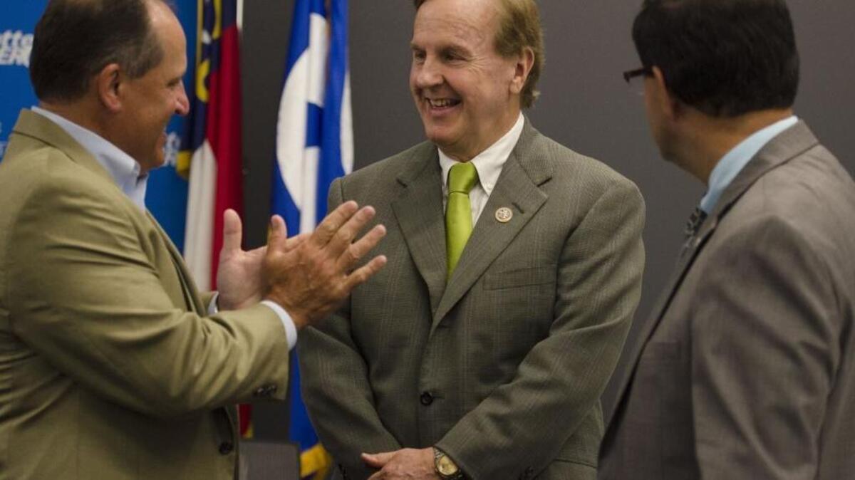 U.S. Rep. Robert Pittenger, center, once called the nation’s rising debt a national security threat. But he defended his recent vote for a spending bill that experts say could add $2 trillion to the national debt.