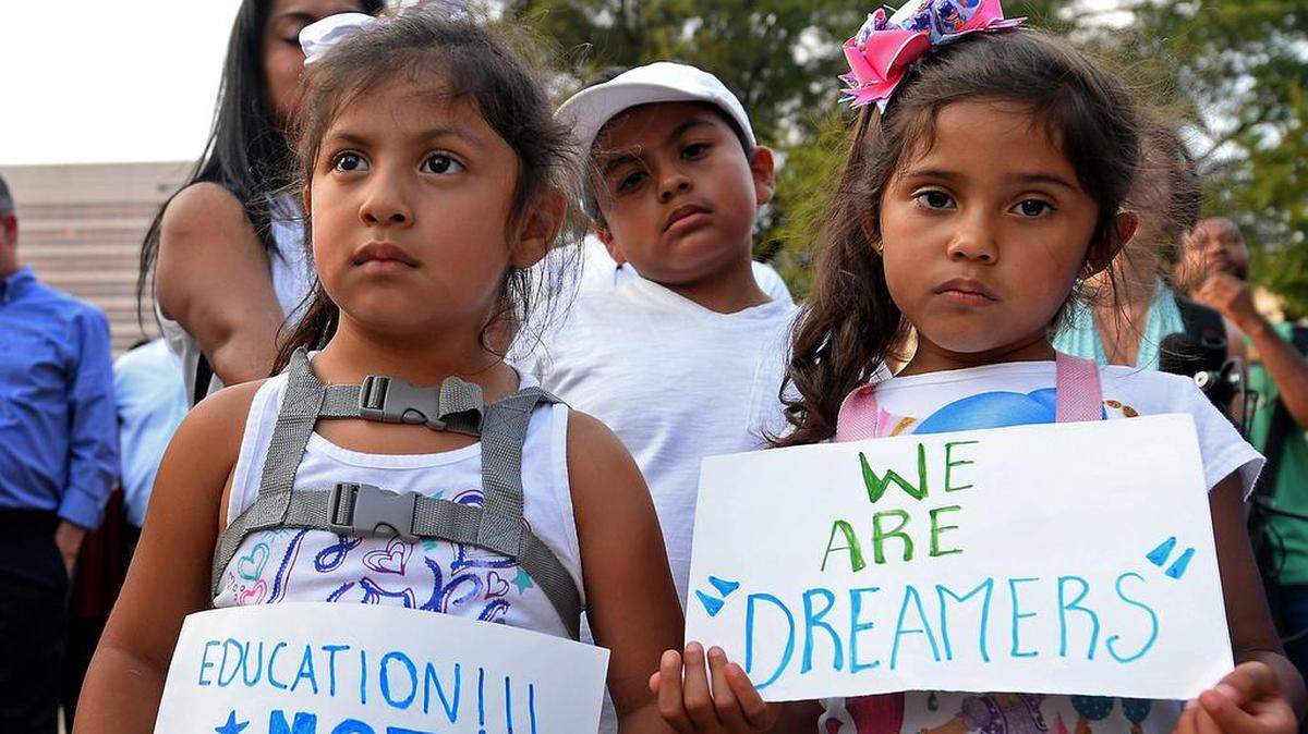 Shendele Melchor, left, Kenny Salazar, center and Alexa Salazar, right, joined other Charlotte residents and immigrants in a show of unity at Marshall Park following the September 2017 announcement that DACA was being rescinded.