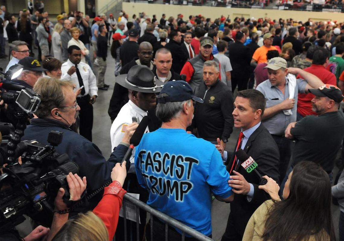 A protester, center, is asked to leave a rally for GOP presidential candidate Donald Trump at the Cabarrus Arena in Concord, NC on Monday, March 7, 2016.
