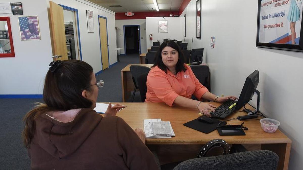 
Juanita Ahl (right), office manager at the Liberty Tax Service in Selma, helps customer Kathleen Johnson start the process of filing her taxes Friday, March 6, 2015. Changes in the North Carolina state income taxes found some people paying money back to the state while others received a refund. 
