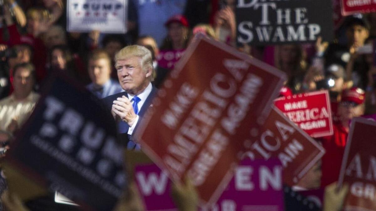 Donald Trump leaves the stage after speaking during a rally at Dorton Arena in Raleigh on the day before Election Day.