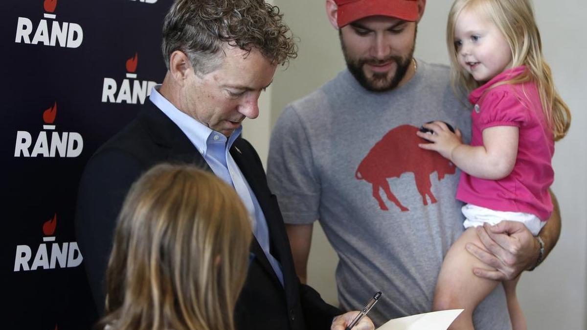 
Republican presidential hopeful Rand Paul spoke at Physician's Choice Laboratory Services in Rock Hill Friday. Rand Paul signs his book "Government Bullies" for Robert Lundy of Charlotte before the event. Lundy brought his daughters Claire, 3, right and Cameron, 10.

