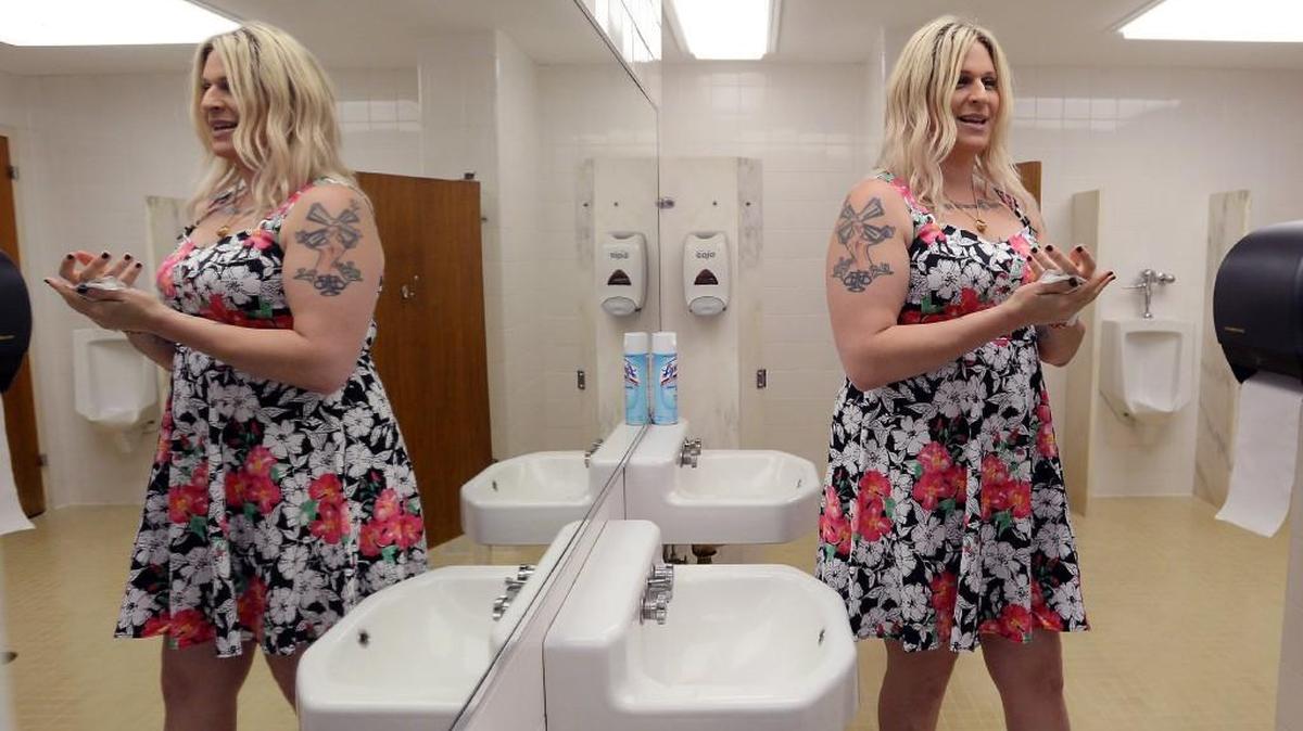 Transgender actress Shakina Nayfack washes her hands after using the men's restroom on the third floor of the Legislative Building in Raleigh, N.C. Friday, June 17, 2017. The actress, from New York, is performing shows in the Triangle this weekend and wanted to see where HB2 was created. She was following the law by using the men's facilities.