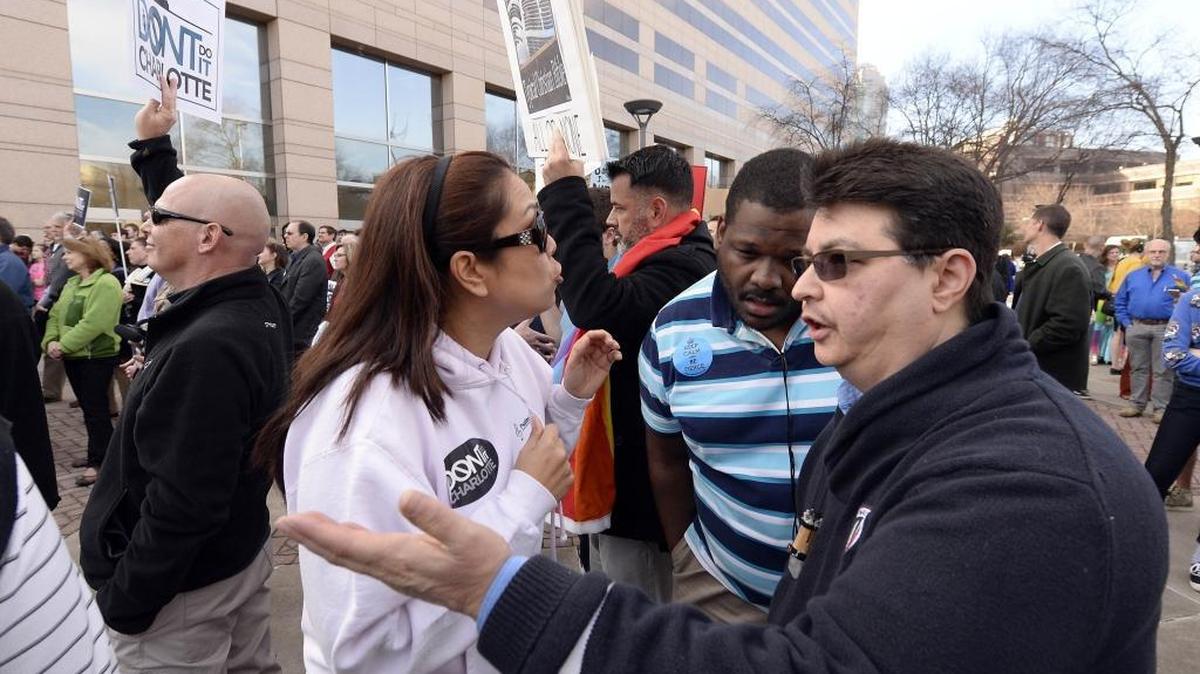 Supporters of Don't Do It Charlotte and supporters of the LGBT community talk during a rally opposed to the proposed non-discrimination ordinance outside the Charlotte-Mecklenburg Government Center prior to the start of the Charlotte City Council on Monday, March 2, 2015.