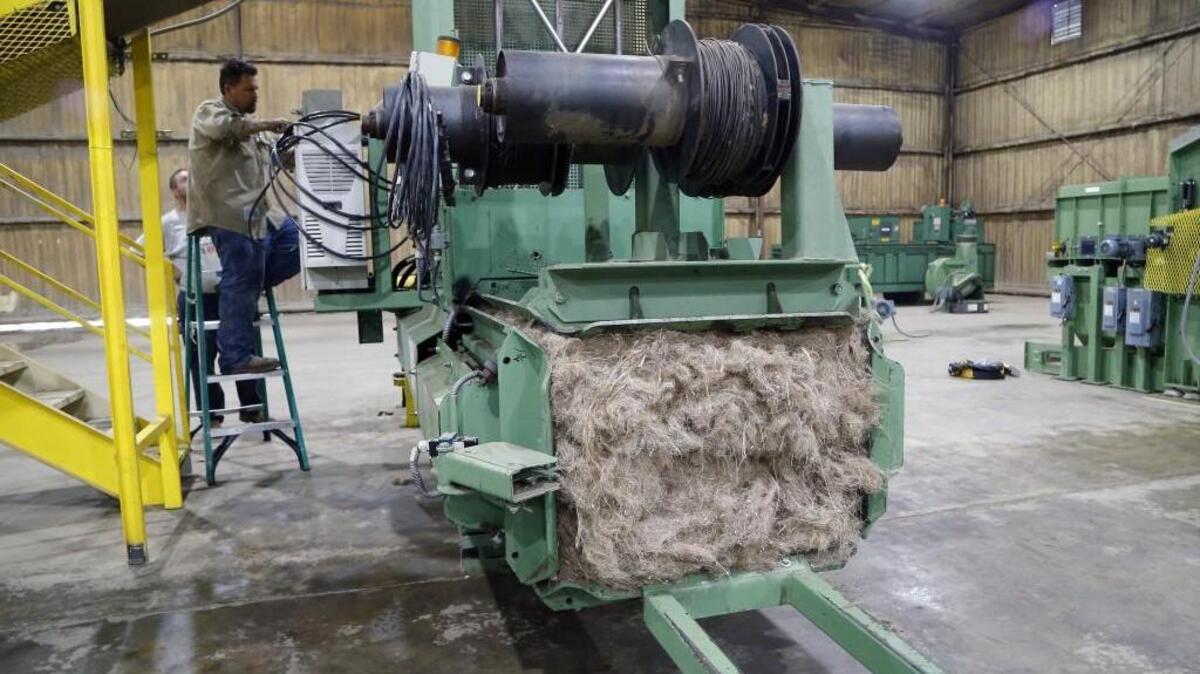 Workers do final assembly of a decortification line at the Industrial Hemp Manufacturing Company in Spring Hope, NC, on Wednesday. The facility hopes to begin full-scale operations when a bill becomes law at midnight Friday, without Gov. Pat McCrory's signature. The law legalizes industrial hemp in North Carolina. Farmers are eager to grow the crop, which can be used in textiles, oil drilling fluid and other products. It has virtually no THC, the active ingredient in marijuana that is smoked. This group of machines separates the outer fibers from the inner core. The outer fibers are used in the textile industry, the core fibers are used by the oil and gas industry. The plant currently processes kanaf, a plant similar to hemp. It is used to make door panels in cars and trucks.