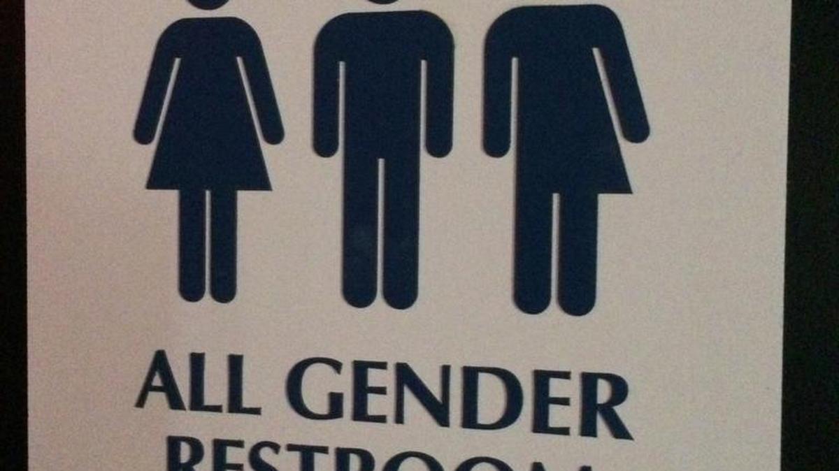 This May 11, 2014 photo shows an "All Gender Restroom" sign outside a bathroom in a bar in Washington. Confrontations have flared across the country over whether to protect or curtail the right of transgender people to use public restrooms in accordance with their gender identity.