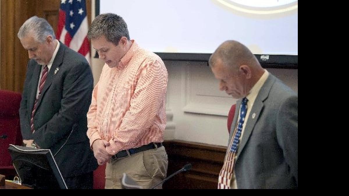 
The Rowan County Board of Commissioners voted unanimously Monday to appeal a recent federal court ruling that said its commissioner-led Christian prayers before public meetings violated the First Amendment of the U.S. Constitution. In this photo Rowan County Commissioners Chair Chad Mitchell, center, prays as commissioners Carl Ford, left, and Jim Sides listen.
