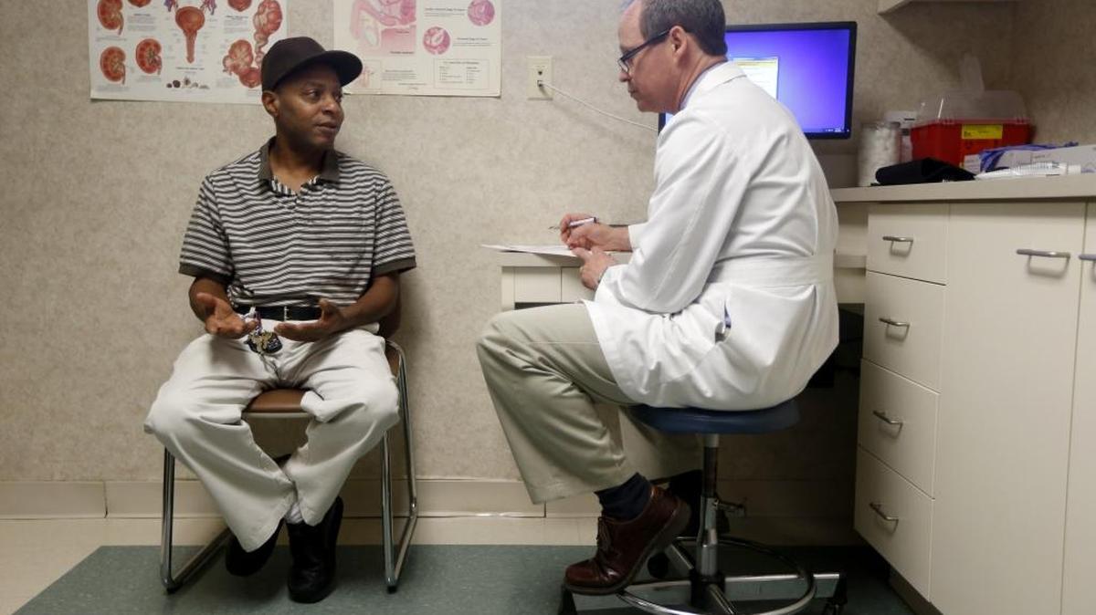 Dr. Greg Murphy talks with Jasper Barrett at Eastern Urological Associates in Greenville on Thursday, April 30, 2015. Barrett had prostate cancer.