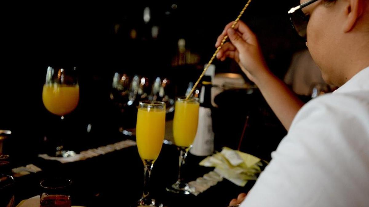 Mimosas are made at the bar as customers enjoy brunch at 5Church restaurant uptown on Sunday.