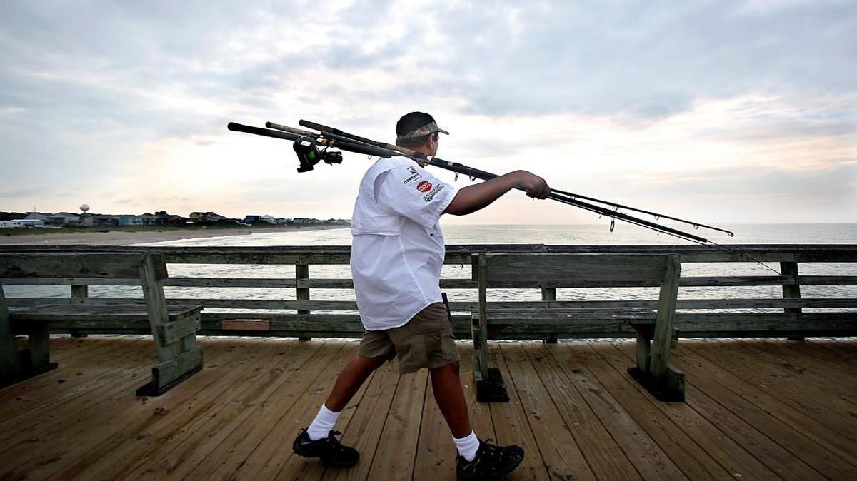 King Mackerel fisherman Sunny Patel, of Emerald Isle, heads to the far end of the Bogue Inlet Fishing Pier in Emerald Isle, N.C. on Monday, July 13, 2015.