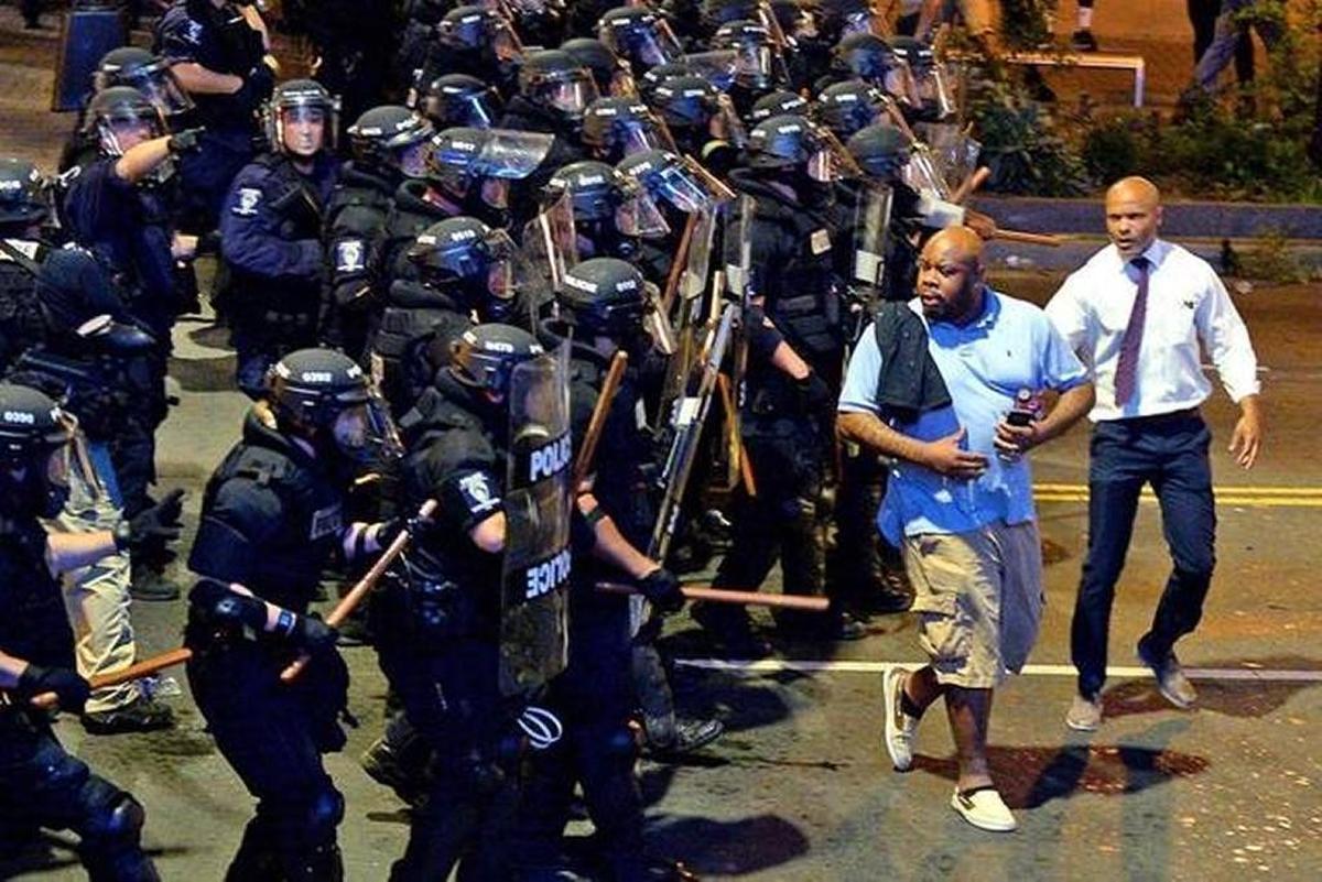 Toussaint Romain, right, gained prominence in 2016 during the unrest following the fatal CMPD shooting of Keith Scott Romain was a public defender at the time.