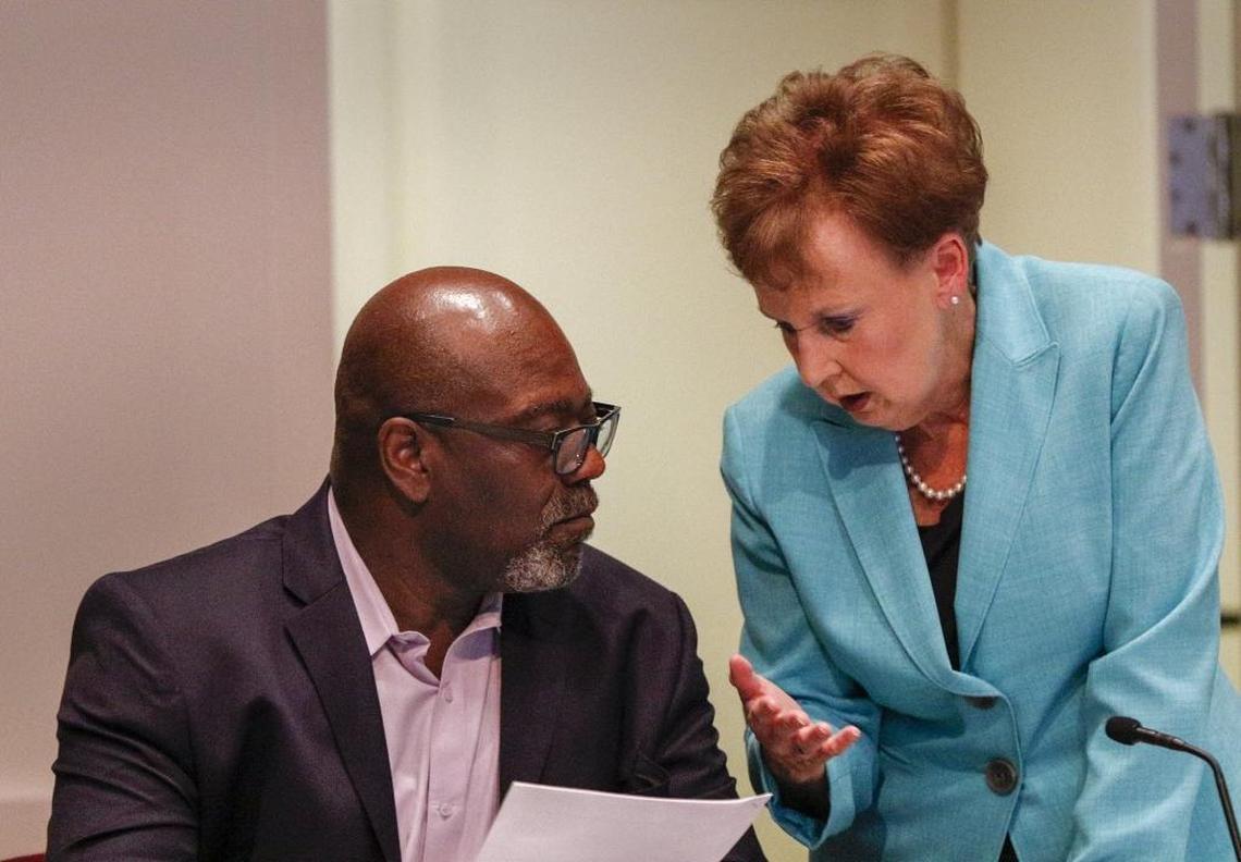 Mecklenburg county commissioner George Dunlap, left, talks with Commissioner Pat Cotham.