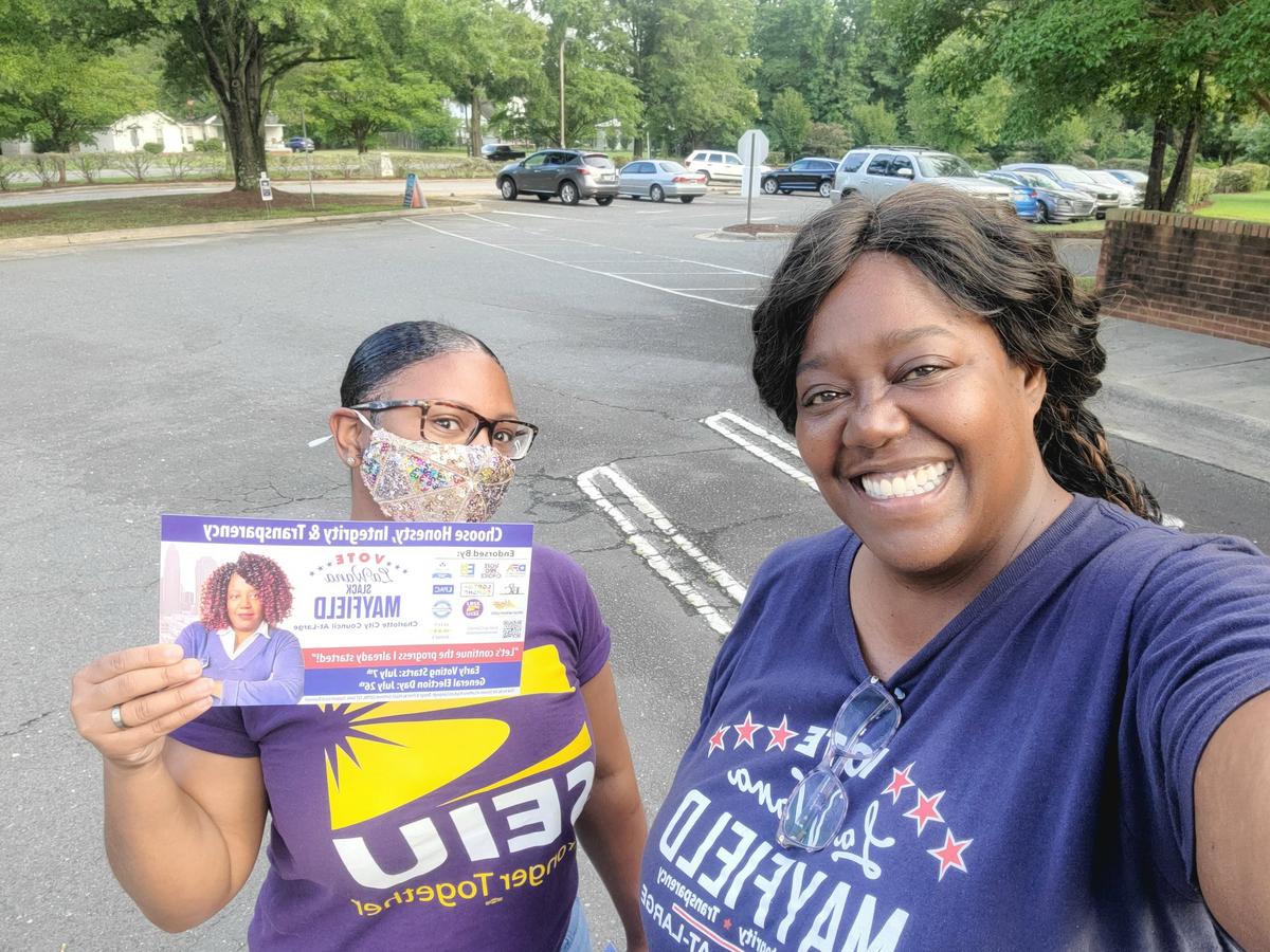 LaWana Slack-Mayfield, right, posing for a selfie Tuesday while visiting polling locations on election day in Charlotte.