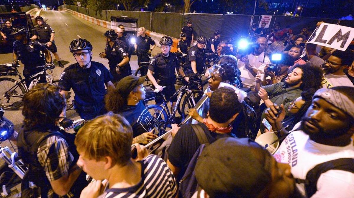 Protesters confront Charlotte-Mecklenburg police officers at the intersection of Church Street on Saturday, September 24,2016. The city of Charlotte said Friday the protests cost taxpayers $4.6 million, mostly due to police overtime.