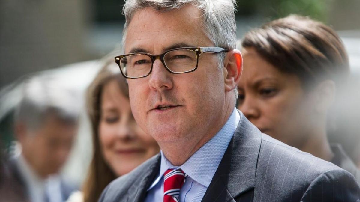 Thomas Walker, United States Attorney for the Eastern District of North Carolina, center prepares to talk with reporters outside federal court May 14, 2015 in Greenville. Walker announced his resignation Tuesday, effective Jan. 7.