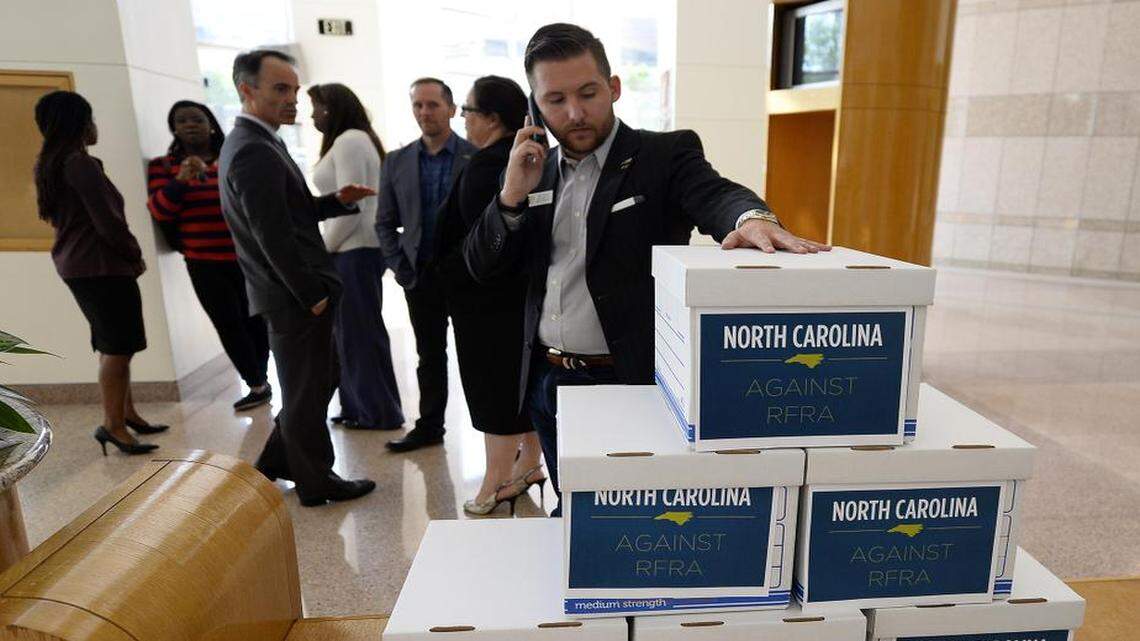 
Matt Hirschy of Equality NC, and other representatives wait to deliver boxes of petitions to Governor Pat McCrory's office on Mondayat the Charlotte-Mecklenburg Government Center in Charlotte, asking him to veto proposals in the General Assembly involving the Religious Freedom Restoration Act. Representatives from local business and faith communities delivered thousands of petitions. 
