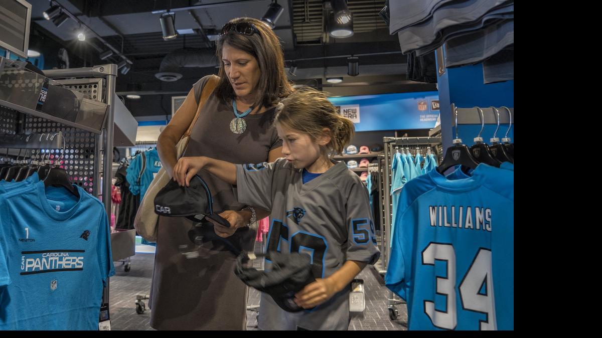 
Alexa Jain and her mother, Astrid, of Charlotte shop at the Carolina Panthers' team shop at Bank of America Stadium on August 7, 2014. A North Carolina Senate proposal could mean that sales tax collected in Mecklenburg County would go to less prosperous areas of the state. 
