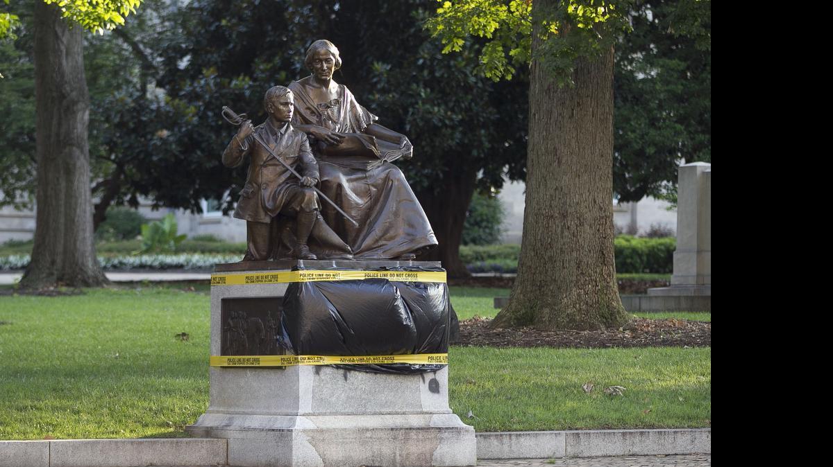
Black plastic and police tape cover the vandalism to the Confederate Women’s Monument on the State Capital grounds on Tuesday morning July 21, 2015 in Raleigh. A block away, the N.C. House debated the fate of Confederate monuments – and who should have the power to take them down. 
