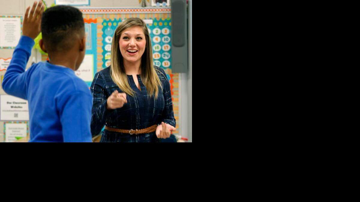 
Teacher Emily Levinson, right, has student Jacobi Walters stand on his chair to be recognized after he got high marks on a computer quiz in her third-grade class at A.B. Combs Elementary School in Raleigh. Gov. Pat McCrory’s budget plan keeps a pledge he made to increase teacher pay, including raising the minimum teacher salary to $35,000 a year.
