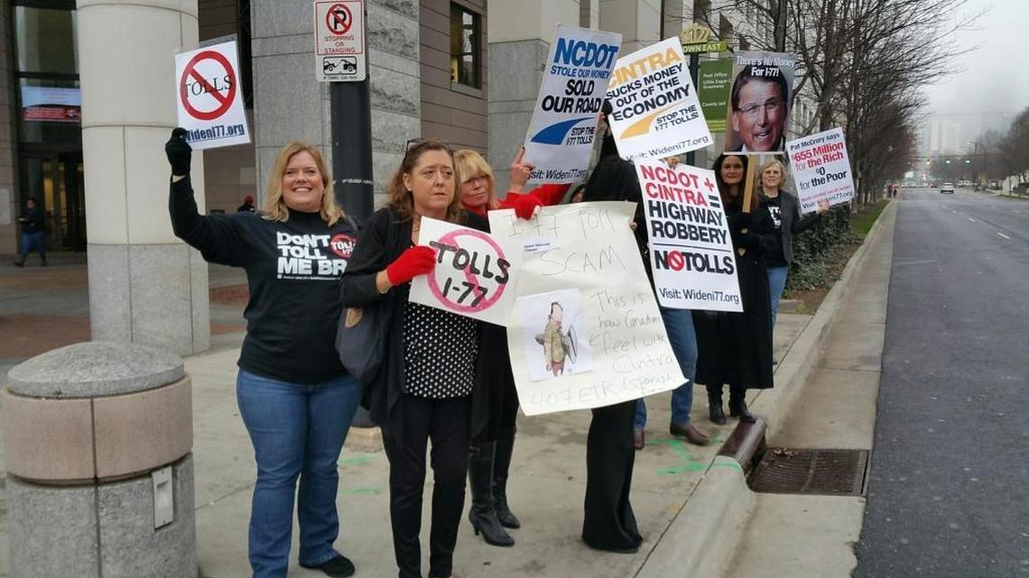 Anti-toll lane protesters make their point outside of the Mecklenburg County Courthouse Friday morning, Jan. 8, 2016.