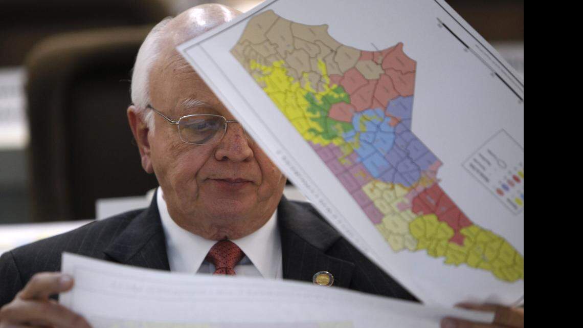 Rep. John Faircloth checks maps during a meeting of joint redistricting committees Monday, Nov. 7, 2011.