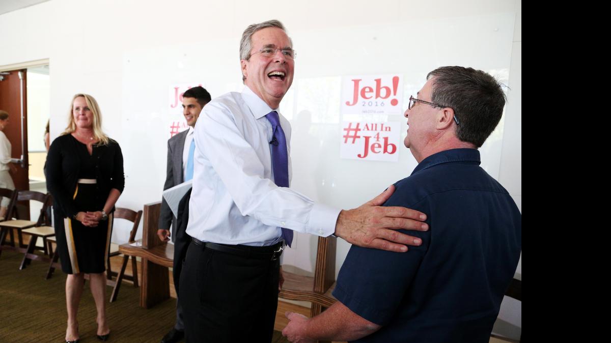 
Jeb Bush, the former Florida governor and frontrunner for the GOP nomination for president, jokes with Joey Vann, an employee at Nephron Pharmaceutical Company, after a tour and speech, Monday, June 29, 2015.
