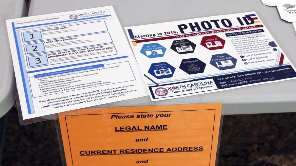 Detail photo of information placards on the welcoming voters’ table in the lobby of the Paul Green Theater on the UNC-CH campus.