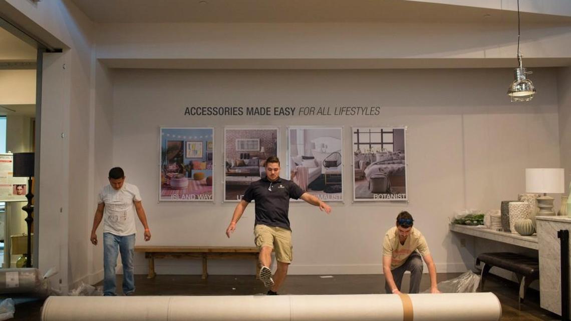 Giovani Escobar, Beaver Goins and Matt Pender get the Surya showroom ready for High Point Market. Dozens of vendors are opting out of the event because of HB2.