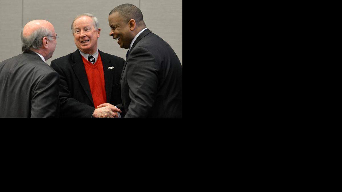 
Charlotte Mayor Dan Clodfelter and Davidson Mayor John M. Woods talk with Transportation Secretary (and former Charlotte Mayor) Anthony Foxx before the start of a transportation roundtable at the Charlotte Convention Center, Thursday morning, Feb. 19, 2015.
