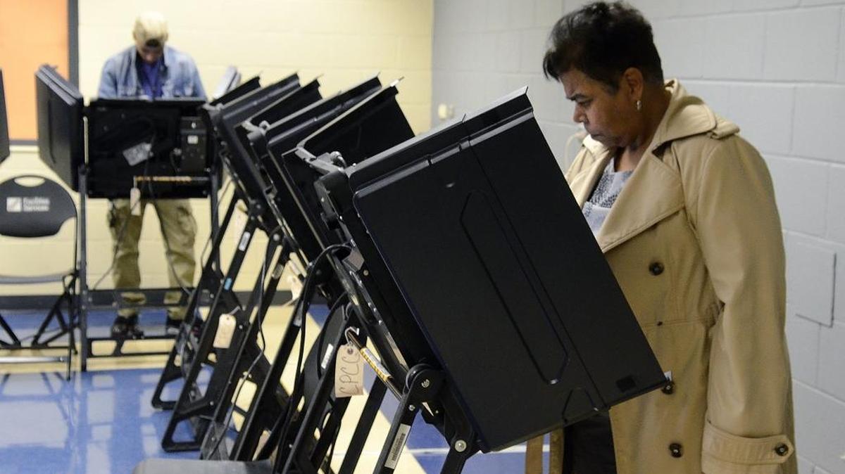 Donovan Cruz (left) and Jeanne Marshall focused on their ballots as they voted in March at the CPCC Facilities Services building.