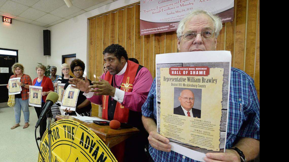 
The Rev. William Barber, at the podium, speaks to the audience naming area legislators into the Hall of Shame for what organizers say is their 'regressive and extreme' voting history.
