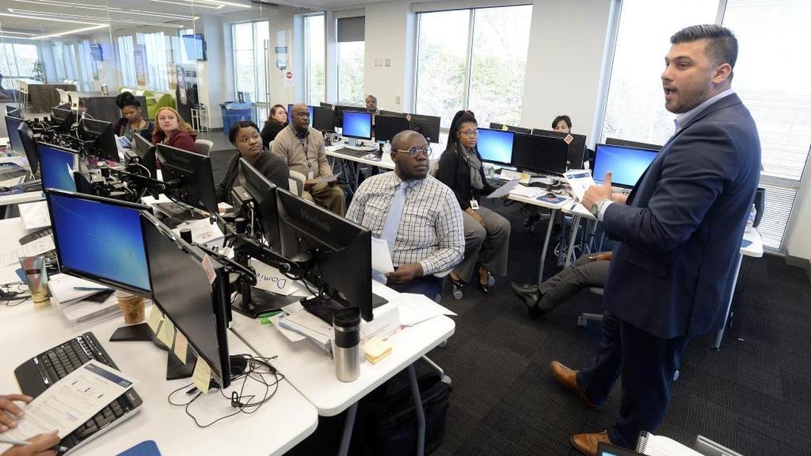 Guillermo Palacios, right, works with a class of call center trainees at the Republic Services call center in Charlotte. Republic received incentives to open the center in Charlotte.