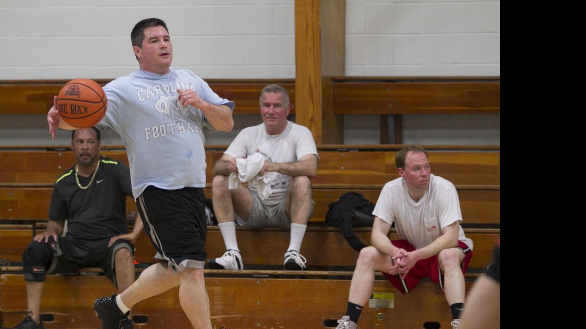 
Sen. Andrew C. Brock of Mocksville runs the offense during a basketball scrimmage with fellow lawmakers and legislative staff.
