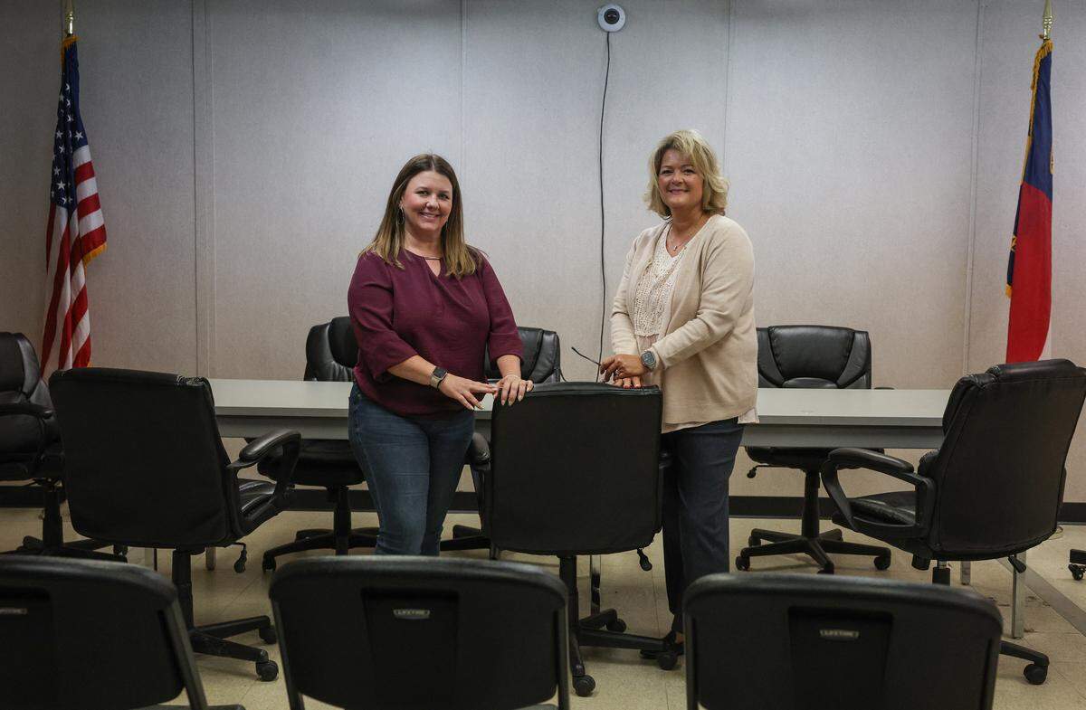 Canton’s finance officer Natalie Walker, left, and town manager Lisa Stinnett stand in the makeshift town hall, which is a large room in a triple-wide trailer. “The working conditions are starting to take a toll on the employees, being in such tight quarters,” says Stinnett.