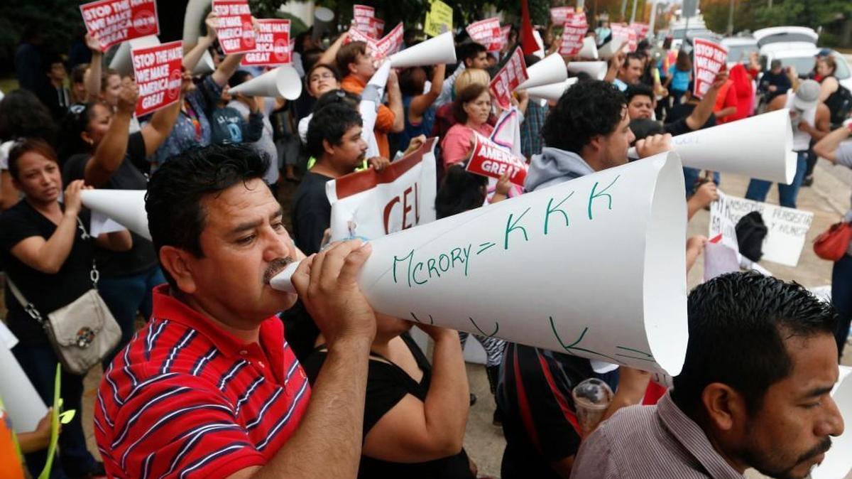 Protester Christobal Rangen, lower left, chants with a larger crowd of about 150 in the 200 block of North Blount Street across from the North Carolina Governor's Mansion. The demonstration in October was to protest Gov. Pat McCrory's signing of HB318, tightening state immigration laws.