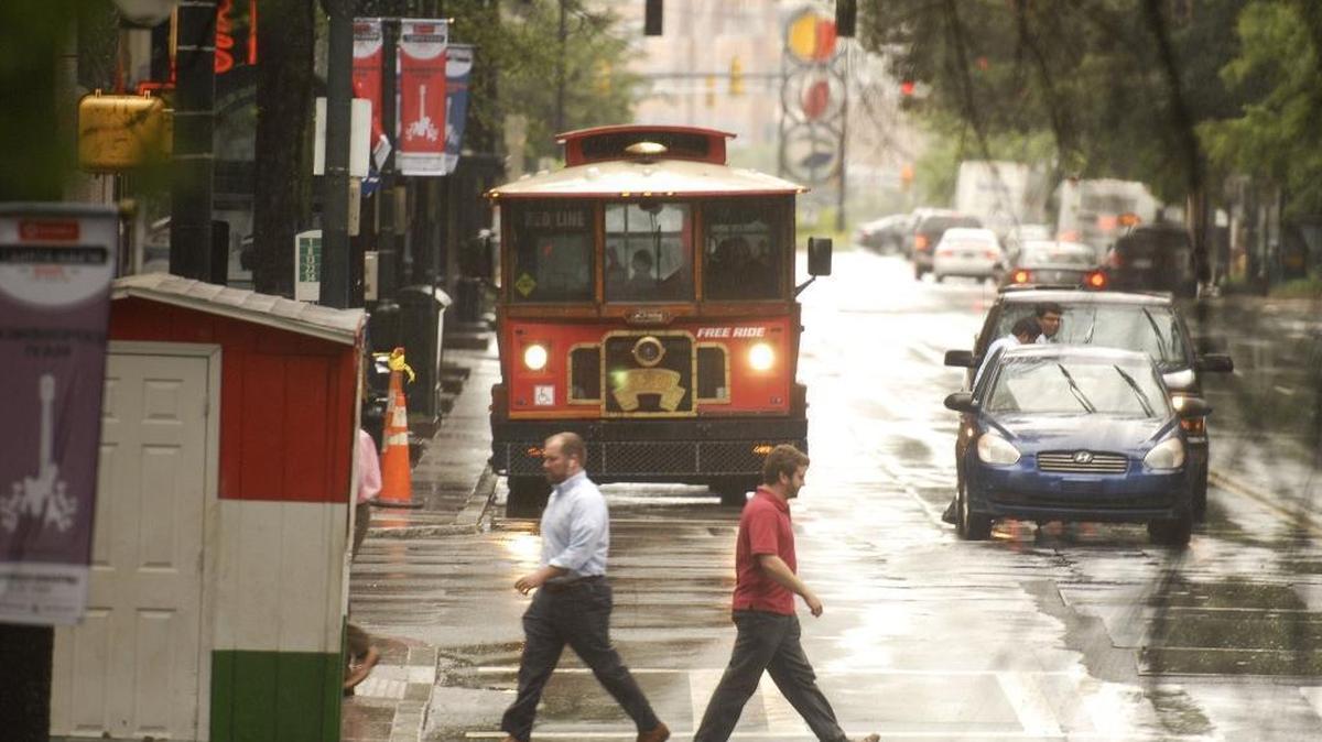 CATS is considering killing the free Gold Rush shuttle that runs from Johnson C. Smith to the Charlotte Transportation Center along Trade Street. Pedestrians cross Trade Street at Tryon Street on Tuesday, May 23, 2017.