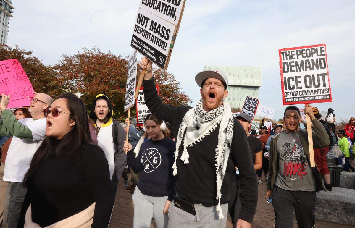Demonstrators march Saturday, Nov. 15, 2025, at the No Border Patrol protest in uptown Charlotte.