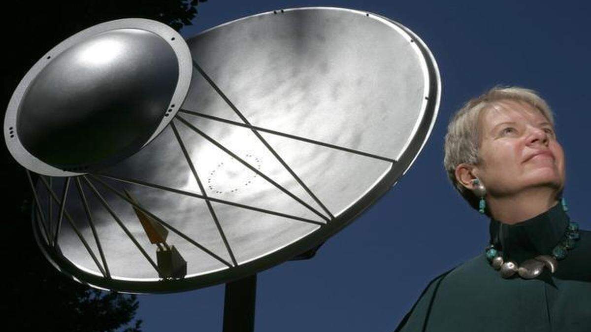 
Jill Tarter, director of the Center for SETI Research, poses with a one-eighth scale model of the Allen Telescope Array, in Mountain View, Calif.
