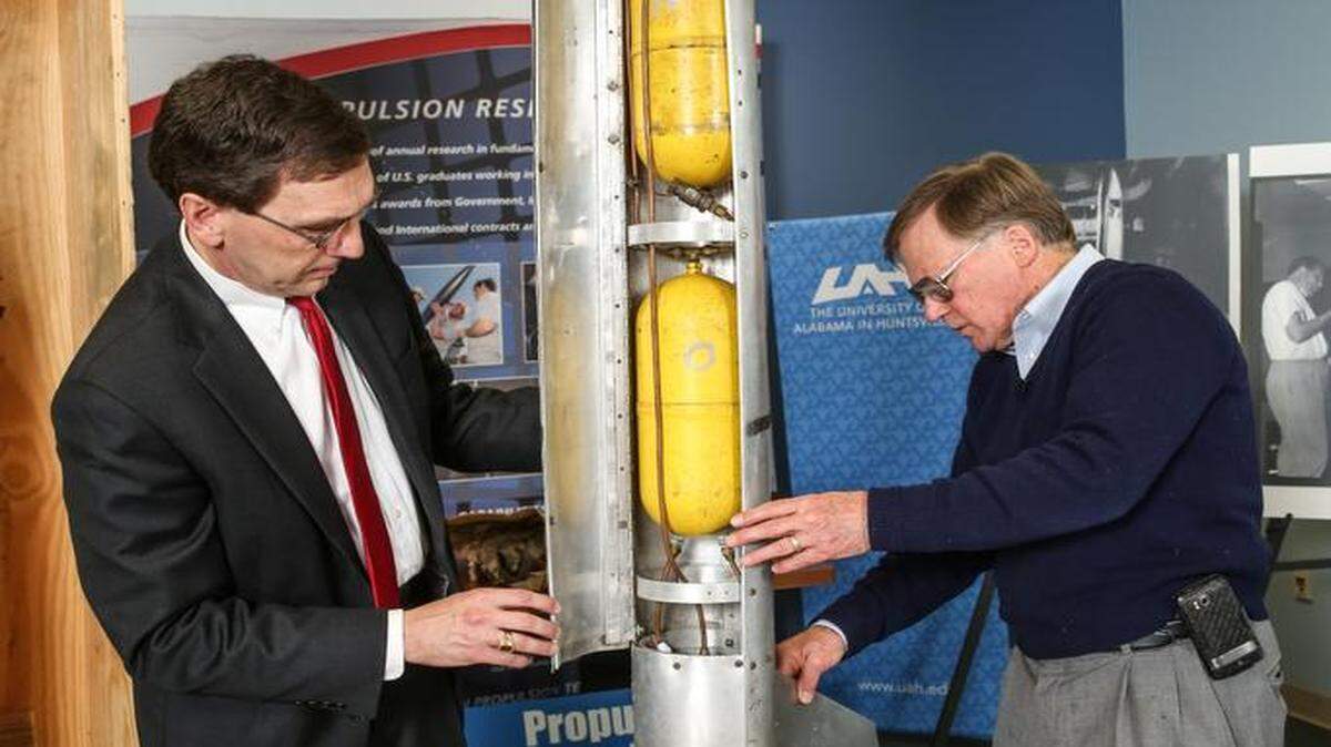 
James Blackmon, principal research engineer for the University of Alabama at Huntsville Propulsion Research Center, right, opens a crate sealed in 1957 that contains a rocket he created as a teen. Robert Frederick, left, director of the Propulsion Research Center was present at the March 19 unveiling.
