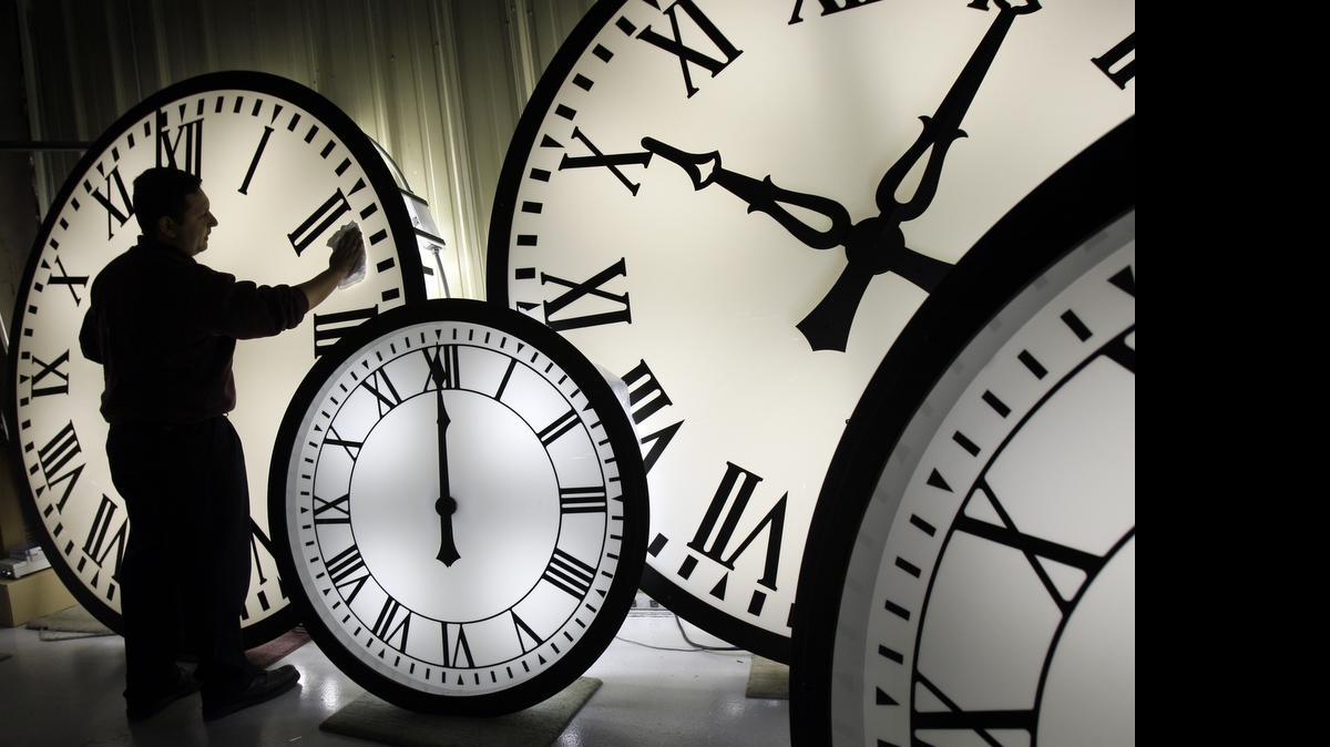 
An employee at the Electric Time Company plant in in Medfield, Mass., cleans the face of an 84-inch Wegman clock. At the close of June 30, clocks internationally will be set back one second. The leap second will align timepieces with atomic clocks, which are pegged to oscillations of a cesium-133 atom, instead of Earth rotation.
