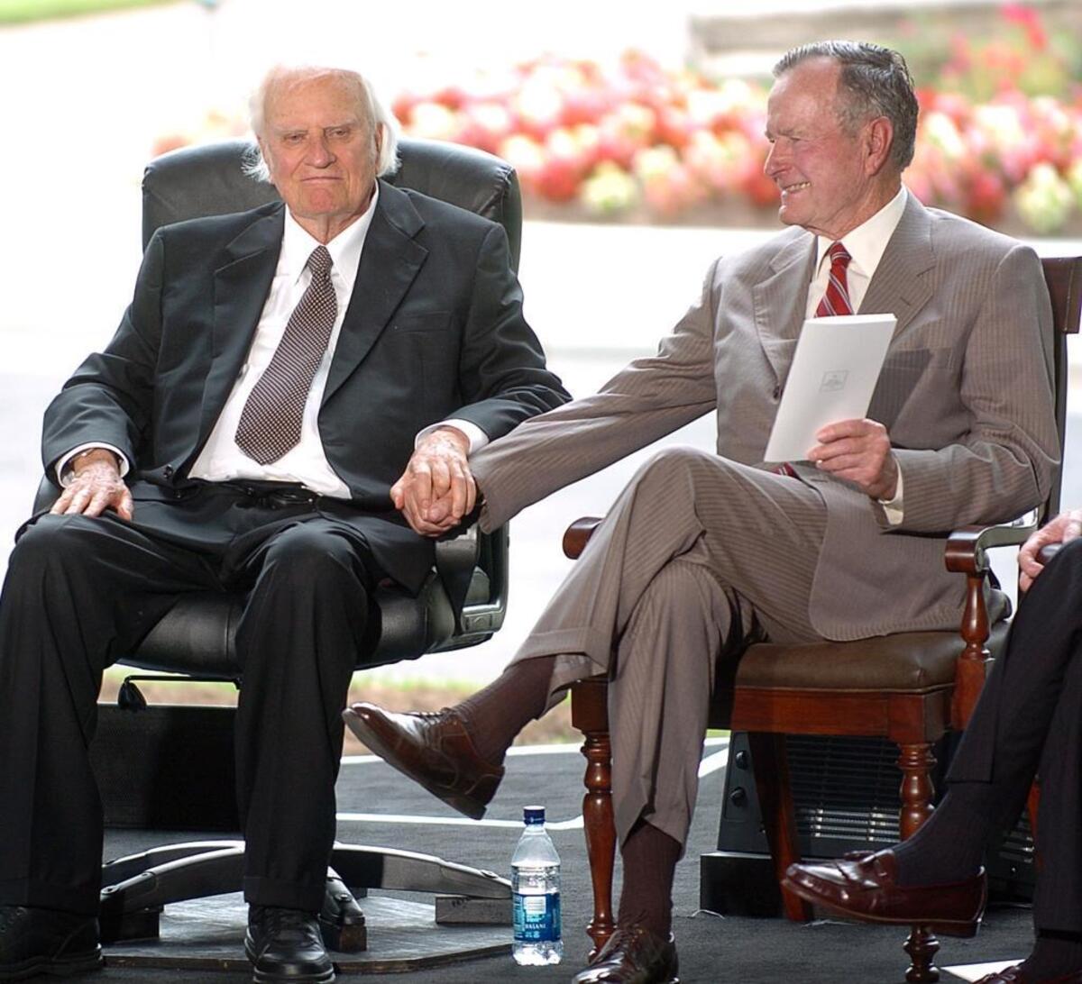 Billy Graham grasps George Bush's hand at the 2007 dedication of the Billy Graham Library.