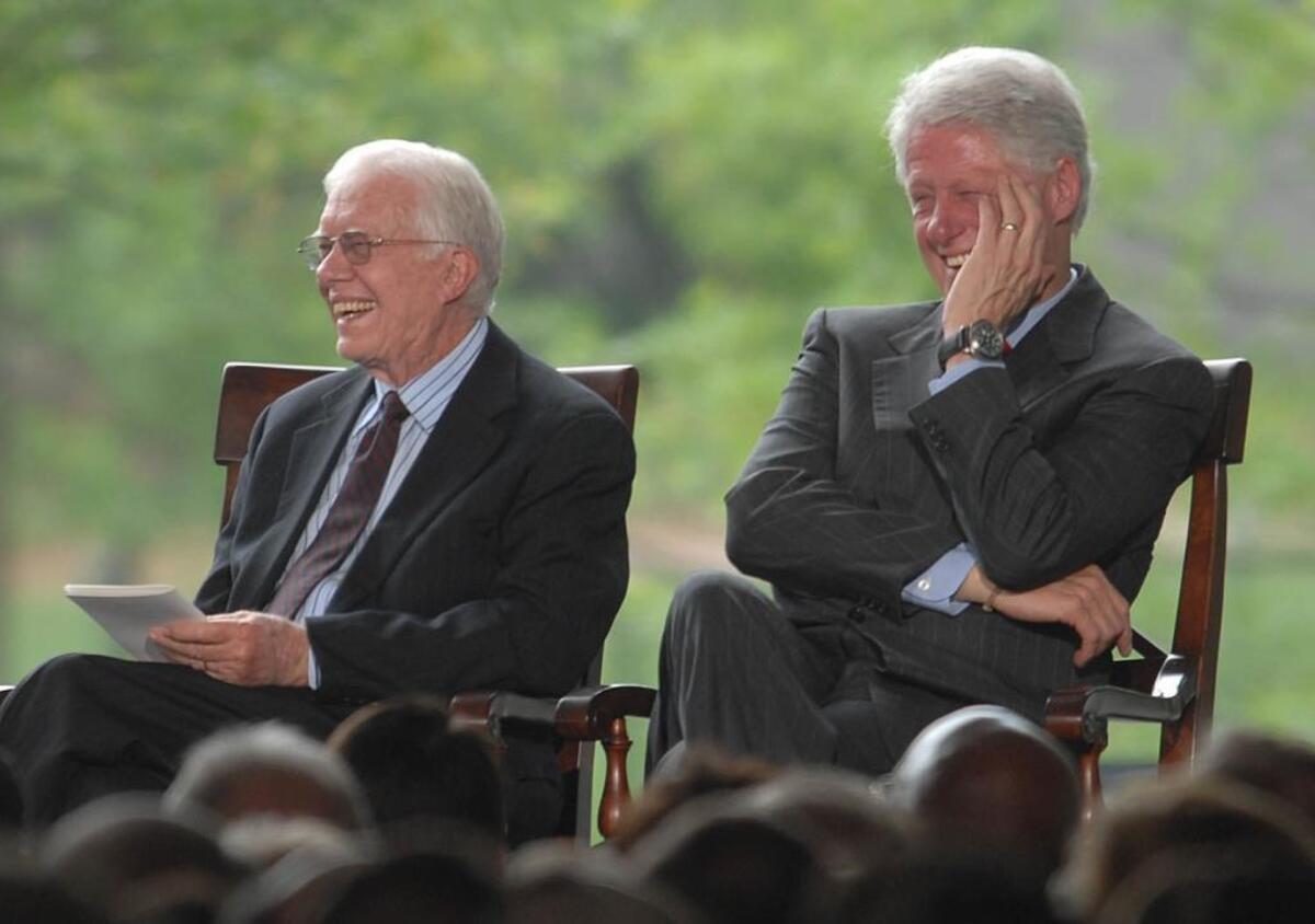 Jimmy Carter and Bill Clinton laugh as George H.W. Bush jokes about them at the Graham Library dedication. two Democrats at The Billy Graham Library Thursday. TODD SUMLIN - tsumlin@charlotteobserver.com