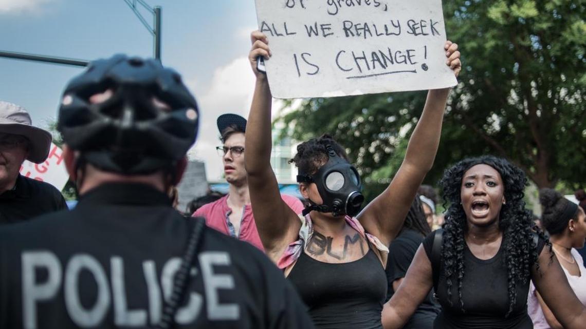 FILE – Demonstrators protest outside of Bank of America Stadium before an NFL football game between the Charlotte Panthers and the Minnesota Vikings, on September 25, 2016, in Charlotte, North Carolina. Protests disrupted the city for a week following the fatal police shooting of 43-year-old Keith Lamont Scott at an apartment complex near UNC Charlotte.