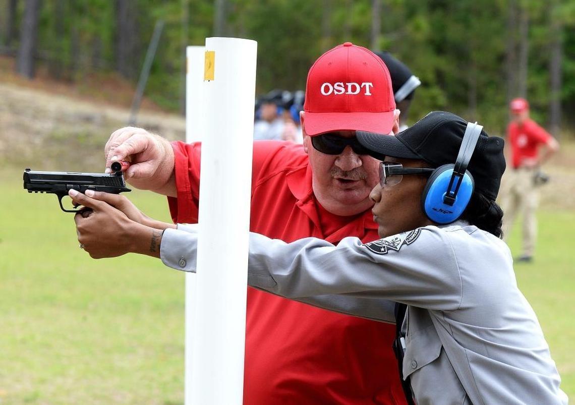 Instructor Rob Martin helps prison officers with firearms training at the Morrison shooting range on McDonald Church Road in Hoffman, NC.